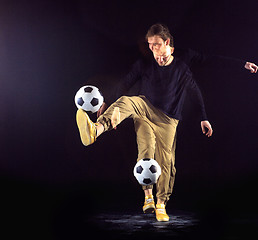 Image showing A portrait of a fan with ball on gray studio background. Freestile