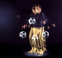 Image showing A portrait of a fan with ball on gray studio background. Freestile