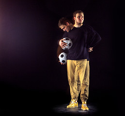 Image showing A portrait of a fan with ball on gray studio background. Freestile