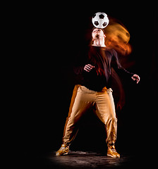 Image showing A portrait of a fan with ball on gray studio background. Freestile