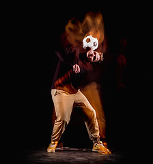 Image showing A portrait of a fan with ball on gray studio background. Freestile