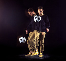 Image showing A portrait of a fan with ball on gray studio background. Freestile