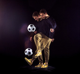 Image showing A portrait of a fan with ball on gray studio background. Freestile