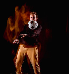 Image showing A portrait of a fan with ball on gray studio background. Freestile