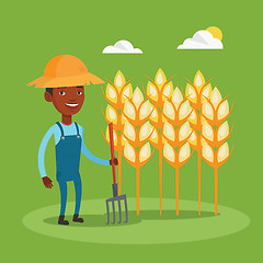 Image showing Farmer with pitchfork at wheat field.