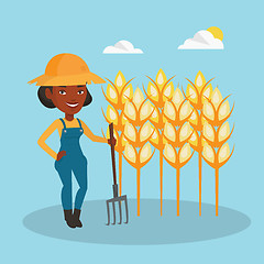 Image showing Farmer with pitchfork at wheat field.