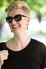 Image showing young woman with short blond hair and sunglasses