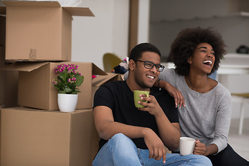 Image showing African American couple relaxing in new house