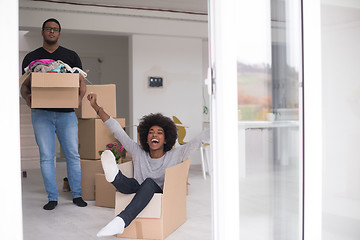 Image showing African American couple  playing with packing material