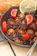 Image showing Baby cuttle fish roasted on iron skillet