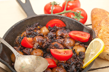 Image showing Baby cuttle fish roasted on iron skillet