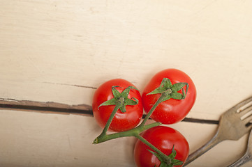 Image showing ripe cherry tomatoes over white wood