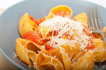 Image showing Italian snail lumaconi pasta with tomatoes