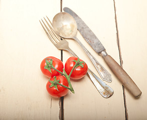 Image showing ripe cherry tomatoes over white wood