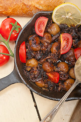 Image showing Baby cuttle fish roasted on iron skillet