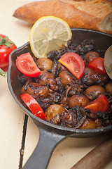 Image showing Baby cuttle fish roasted on iron skillet