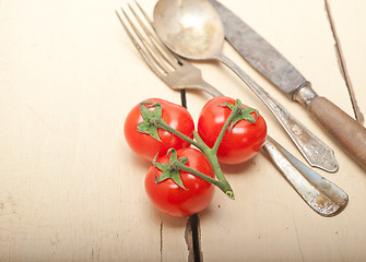 Image showing ripe cherry tomatoes over white wood