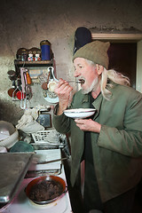 Image showing Old man tasting food