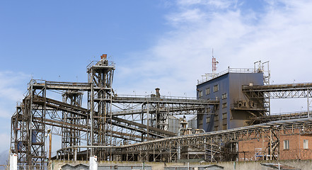 Image showing Pipes oil refining factory against a blue sky