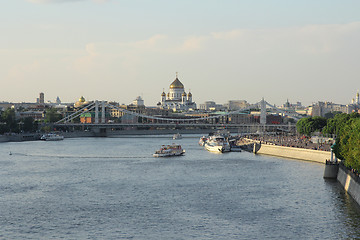 Image showing Moskva river with river buses from Novoandreevskiy Bridge. Krymsky bridge and Cathedral of Christ the Savior on the horizon in Moscow, Russia