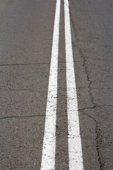 Image showing Texture of an asphalt road with a top view of a double white strip