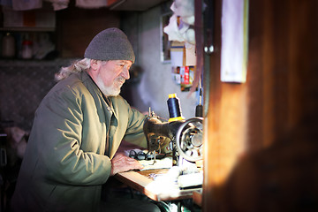 Image showing Man sewing at home