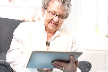 Image showing Grandma and the computer. Older woman with a tablet.