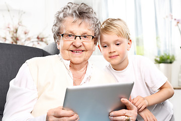 Image showing Grandmother with grandson playing on the tablet.