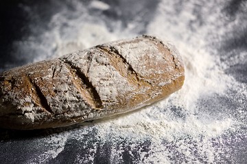 Image showing Fully baked bread on flour