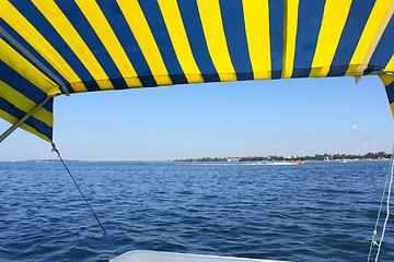 Image showing Blue and yellow tent above water surface