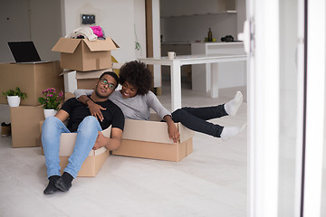 Image showing African American couple  playing with packing material