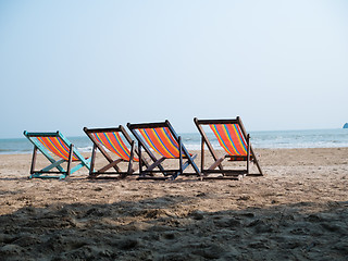 Image showing Four deck chairs on beach