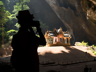 Image showing Woman with camera against sun