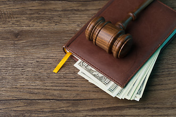 Image showing Wooden table with hammer, money