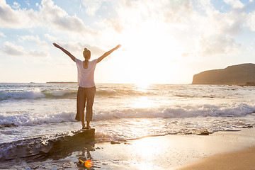 Image showing Free Happy Woman Enjoying Sunset on Sandy Beach