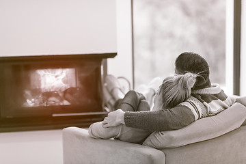 Image showing Young couple  in front of fireplace
