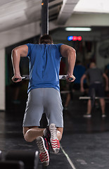 Image showing man doing exercises parallel bars