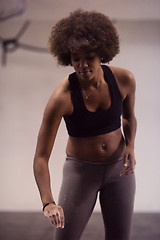 Image showing black female athlete is performing box jumps at gym