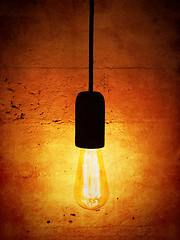 Image showing Light bulb on vintage orange background