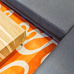 Image showing Gray corner sofa and orange carpet