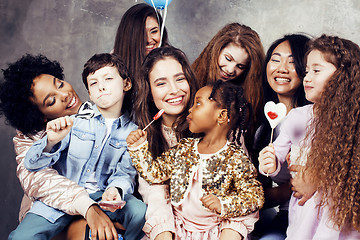 Image showing Lifestyle and people concept: young pretty diversity nations woman with different age children celebrating on birth day party together happy smiling, making selfie. African-american, asian and caucasi