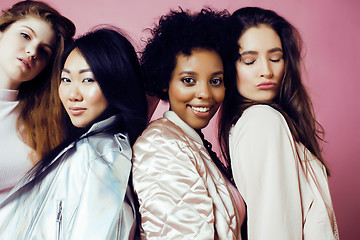 Image showing different nation girls with diversuty in skin, hair. Asian, scandinavian, african american cheerful emotional posing on pink background, woman day celebration, lifestyle people concept 