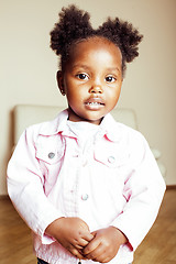 Image showing little cute african american girl playing with animal toys at home, pretty adorable princess in interior happy smiling, lifestyle people concept