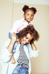 Image showing adorable sweet young afro-american mother with cute little daughter, hanging at home, having fun playing smiling, lifestyle people concept, happy smiling modern family
