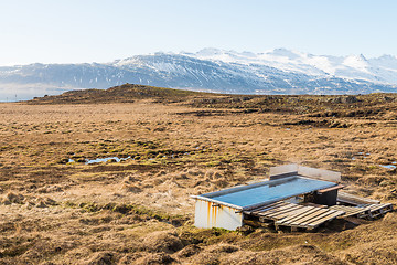 Image showing Icelandic hotpot among the amazing lagoon and mountains