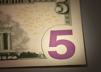 Image showing   number 5 on the dollar bill