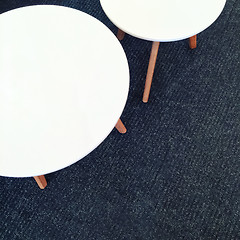 Image showing Round white tables on carpet floor