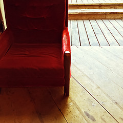 Image showing Rustic interior with vintage red velvet armchair
