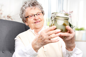 Image showing Grandma's preserves, delicious place the jars for the winter Grandma's pantry, cucumbers in a jar