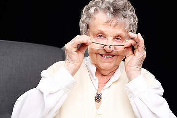 Image showing Cheerful, smiling old woman sitting in the chair 